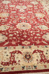 Wide ivory border with Safavid leaf design on a traditional cherry red Sultanabad carpet.