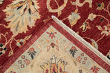 Corner detail showing the back weave, intact fringe, and plush red pile of a Sultanabad carpet.