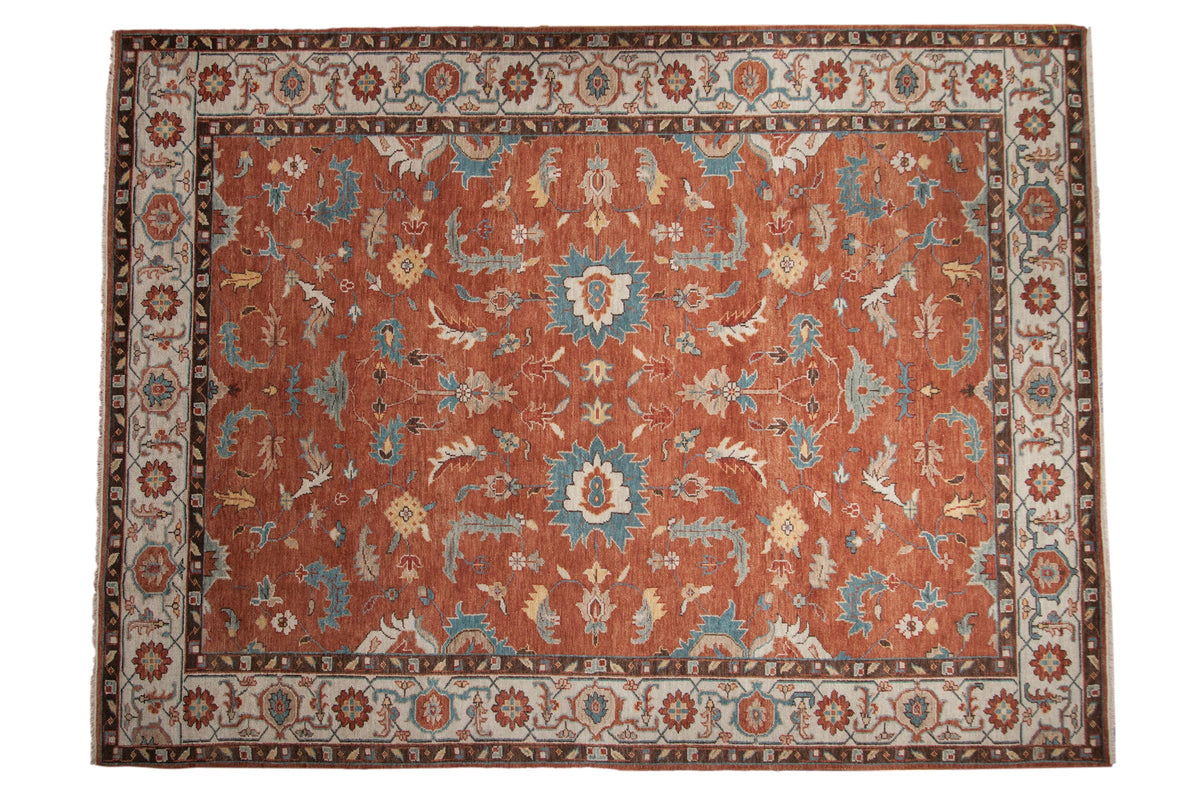 Indian Mahal carpet with large floral cross sections on a copper field, accented with turquoise, ivory and saffron.