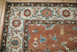 Classic turtle samovar border with floral motifs on a hand-knotted Mahal carpet.