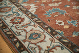 Close-up of the Indian Mahal rug's classic turtle samovar border and copper floral field.