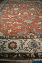 Low-angle view of the Indian Mahal carpet's copper field and ivory turtle samovar border.