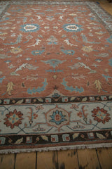 Low angle view of a Mahal carpet's turtle samovar border and copper floral field.