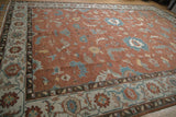 Angled view of the Indian Mahal carpet's ivory turtle samovar border and copper floral field.