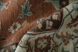 Textured close-up of a folded Mahal carpet revealing its classic turtle samovar border design.
