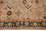 Detailed corner showing the deep teal border and floral palmettes of a vintage Indian rug.