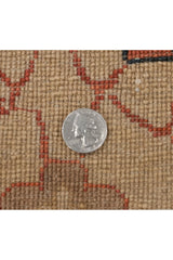 Close-up of the dense, hand-knotted weave and full pile of a vintage Indian carpet, with a coin for scale.