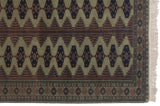 Corner of a vintage Siberian rug with a geometric border, navy guls, and intact white fringe.