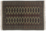 Vintage Siberian Bokhara rug with dual columns of serrated navy guls on a sage green and apricot field.