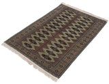 Angled view of a Siberian Bokhara rug showing the sage green field and navy geometric guls.