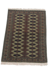 Angled perspective of the vintage Siberian Bokhara rug showing its dual column gul design.