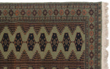 Crisp geometric border and intact side cord on a sage green vintage Siberian Bokhara rug.