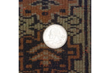 Full hand-knotted pile of a vintage Siberian Bokhara rug with a quarter shown for scale and density.