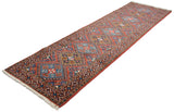 Vintage Ardebil runner shown at an angle, emphasizing the column of alternating geometric medallions.