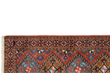 Corner detail of the vintage Ardebil runner's pinwheel floral border and ivory fringe.