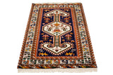 Vintage Northwest Persian design rug corner, navy field with saffron yellow stylized lions and fringe.