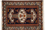 Vintage Indian rug corner with navy blue field, rust border, stylized lions, and deer.