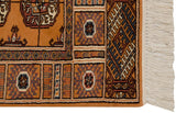 Corner of a vintage Bokhara rug showing the plush pile, geometric border, and ivory fringe.