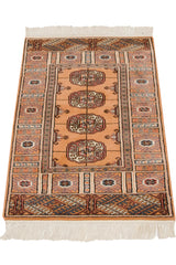 Full length of a vintage Bokhara rug showing the plush pile and saffron yellow guls.