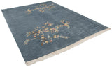 Vintage Indian Art Deco rug in denim blue with diagonally oriented floral sprays and floating carved border.