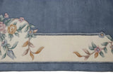 Ivory Aubusson design vinery with pink blossoms, seafoam green, and coffee leaves on denim blue.