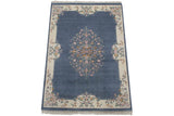 Curvilinear floral spray on denim blue and ivory vintage Indian Aubusson design rug.