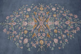 Detail of vintage Aubusson rug's floral spray, with pink roses, yellow buds, and seafoam vinery.