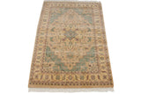 Corner of vintage Indian Heriz rug, showing detailed floral border and seafoam green vinery.