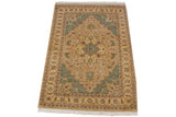 Hand-knotted Indian Heriz rug corner with seafoam green stepped design and floral vine border.