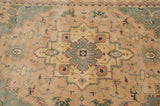 Stepped medallion, serrated floral vinery in seafoam green, dusty blush on Indian Heriz carpet.