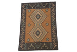 Stepped diamond medallion and pale green germinating plant border on a vintage Dhurrie rug.