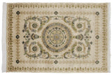 Embossed floral borders and polished wool pile corner of a vintage Savonnerie design rug.