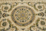 The embossed contour of the roundel medallion in sage, silver, and moss green.