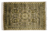 Embossed olive green Savonnerie floral borders with scrolled arabesques and white fringe.