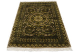 Embossed olive green Savonnerie rug with scrolled arabesques, blossom border, and fringe.
