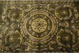 Embossed wool pile of Indian Savonnerie rug, roundel medallion, arabesques, olive, bronze.