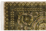 Embossed olive green pile, white fringe, and scrolled arabesque floral border of a vintage Indian Savonnerie rug.