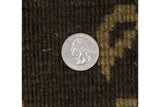 Polished wool pile in olive green, dusty bronze, showing embossed contour, quarter for scale.