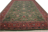 Forest green field with floral palmettes, brick red border, and cream fringe of the vintage Meshed rug.