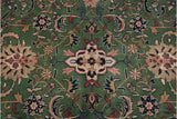 Blush lotus flowers and elaborate palmettes on the forest green Indian Meshed carpet.