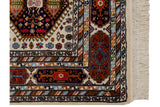 Multi-cartouche main border with geometric plants and crisp ivory fringe.