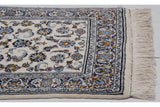Intact ivory fringe and intricate border pattern with navy and bronze tones.