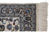 Full pile vintage Indian Isfahan rug corner, ivory field, blue palmettes, bronze vines, and fringe.