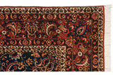 Intricate corner spandrel of a vintage Bakhtiari rug showing paisley botehs, detailed borders, and ivory fringe.