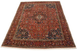 Vintage Bakhtiari carpet at an angle, showcasing the medallion, deep blue spandrels, and red boteh field.