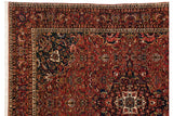 Intricate corner spandrel, floral borders, and ivory fringe of a hand-knotted Bakhtiari rug.