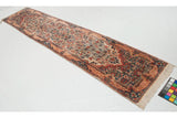 Vintage Kerman runner from an angle, showing the dense thousand flower pattern on an ivory field.