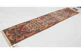 Vintage Kerman runner from an angle, highlighting its long profile and thousand-flower design.