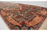 Low angle on the vintage Kerman runner's corner, detailing the plush pile and Rococo-style border.