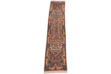 Angled view of a vintage Kerman runner showing its full length and intricate thousand-flower pattern.